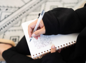 Blog Image of woman writing in journal - 5 Mindset Shifts Needed To Build A Real Estate Team