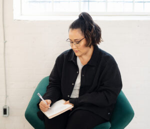 Picture of Jess Sitting while Journaling | Real Estate Mindset | The Listings Lab