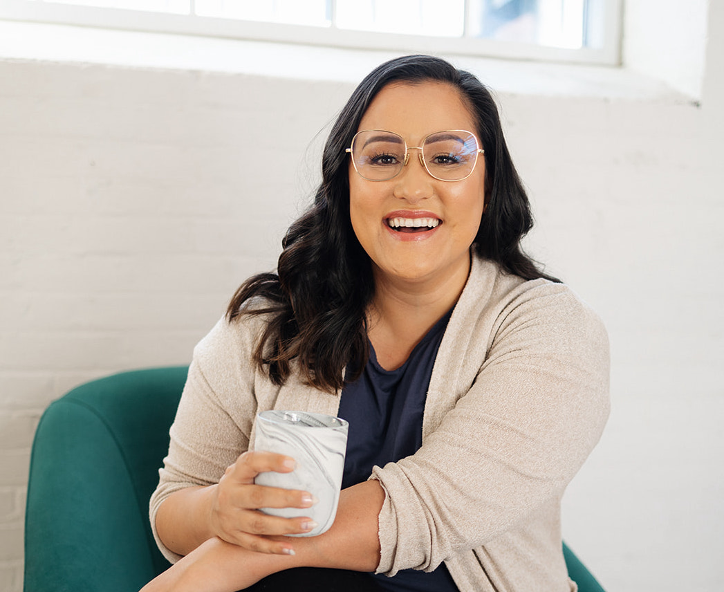 Picture of Jess Smiling on Camera While Holding a Cup of Hot Drink | 10x thinking | The Listings Lab