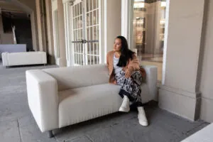 Picture of Jess Lenouvel Sitting on a White Couch | Maximize Your Return on Investment Blog Post | The Listings Lab