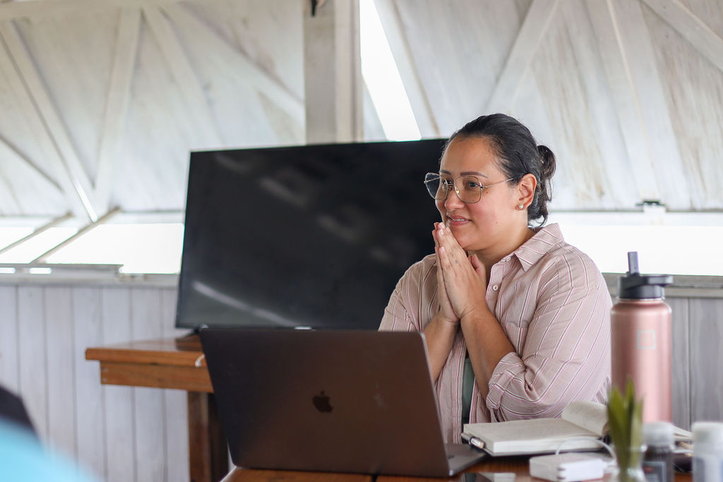 Picture of Jess Lenouvel from The Listings Lab Standing in Front of her Laptop Being Thankful while Listening to her Audience