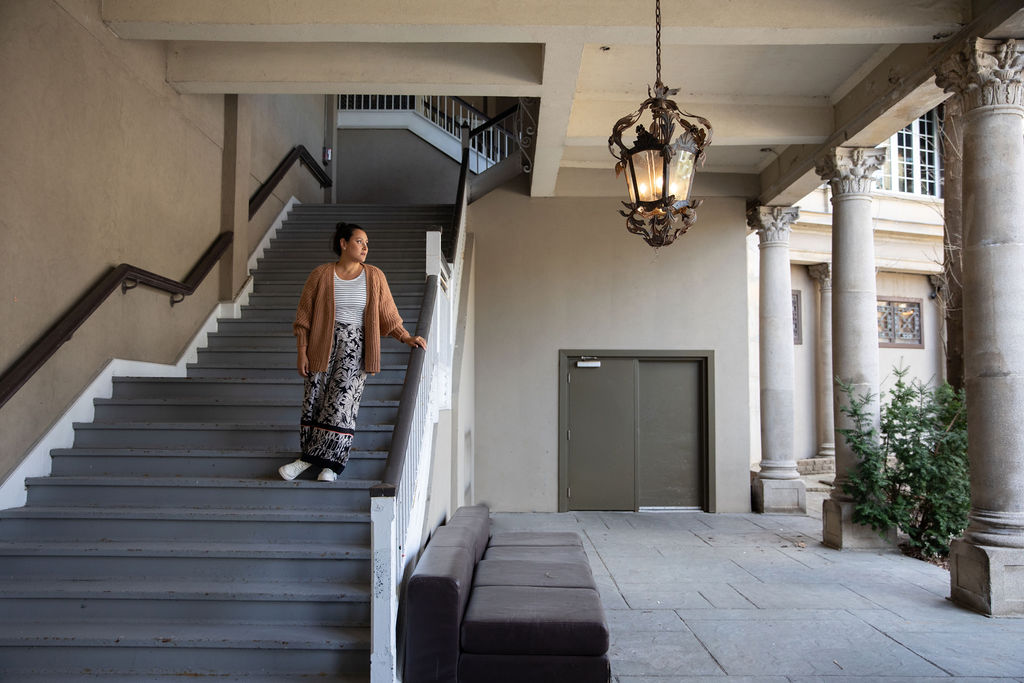 Picture of Jess Lenouvel Going Down the Stairs While Looking to the Side | Real Estate Sales | The Listings Lab